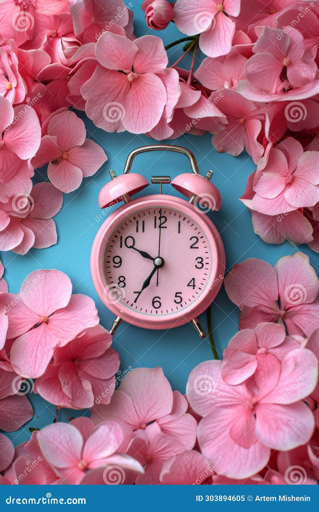 A Classic Pink Alarm Clock Surrounded by Soft Pink Hydrangea Petals on