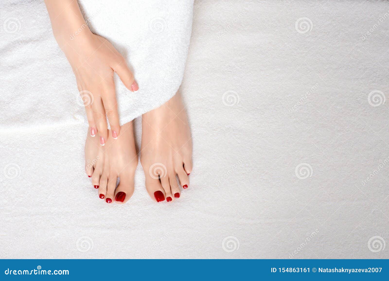 Classic Red Pedicure Treatment Female Feet And Hand On White Terry