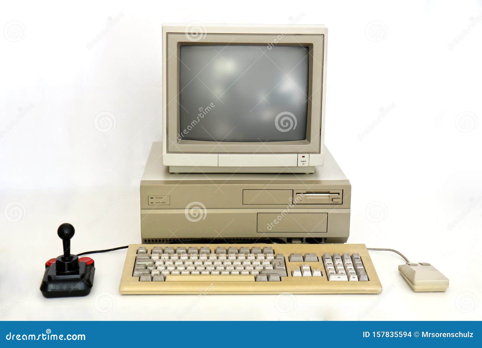 classic retro pc from the eighties with monitor, mouse and joystick. used for gaming, writing and graphics on white