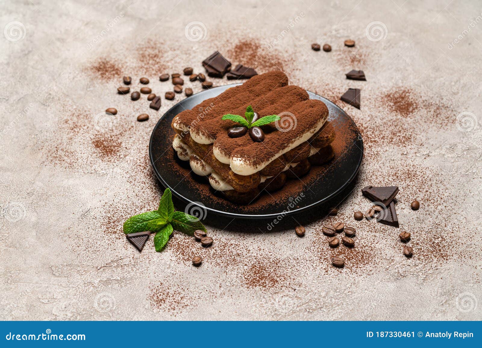 Classic Tiramisu Dessert on Ceramic Plate on Concrete Background Stock