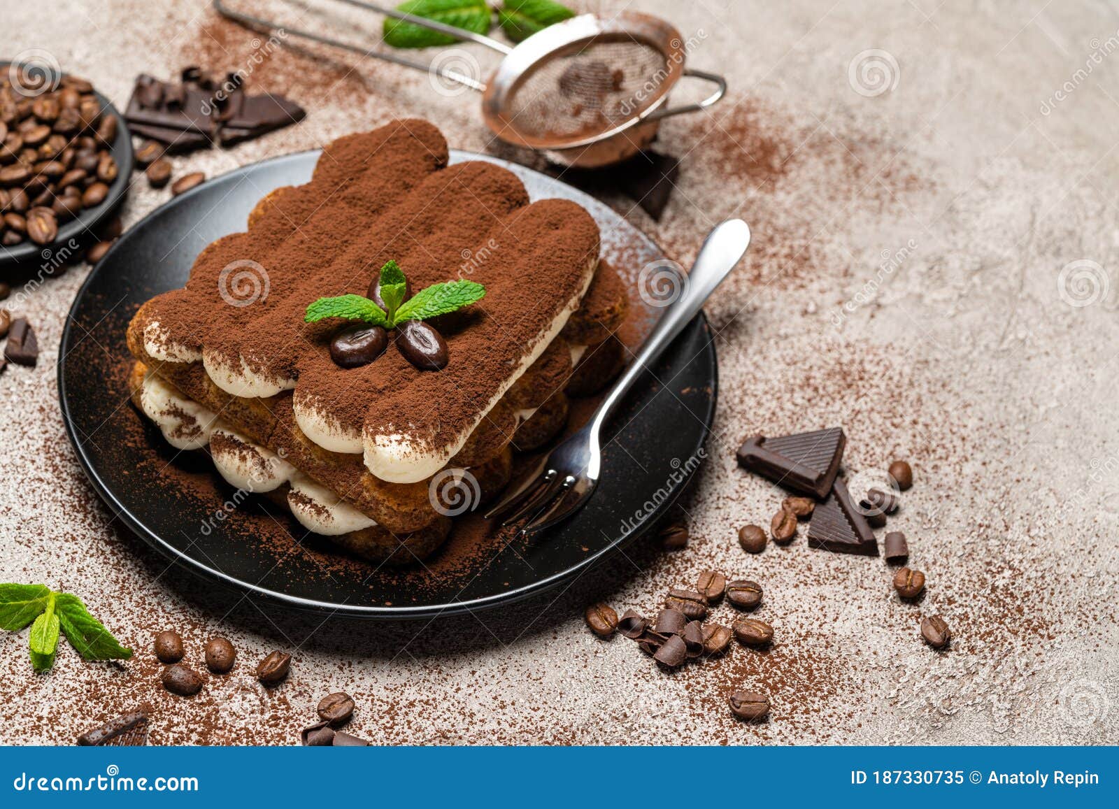 Classic Tiramisu Dessert on Ceramic Plate on Concrete Background Stock