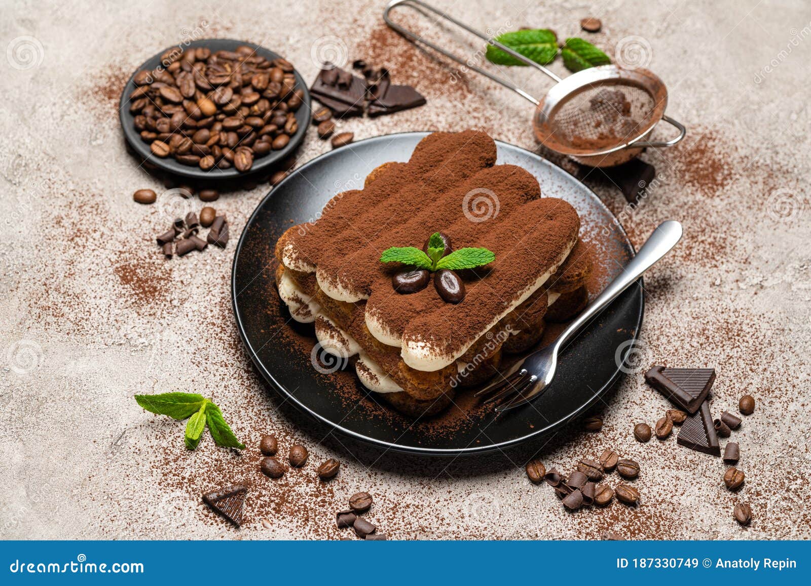 Classic Tiramisu Dessert on Ceramic Plate on Concrete Background Stock