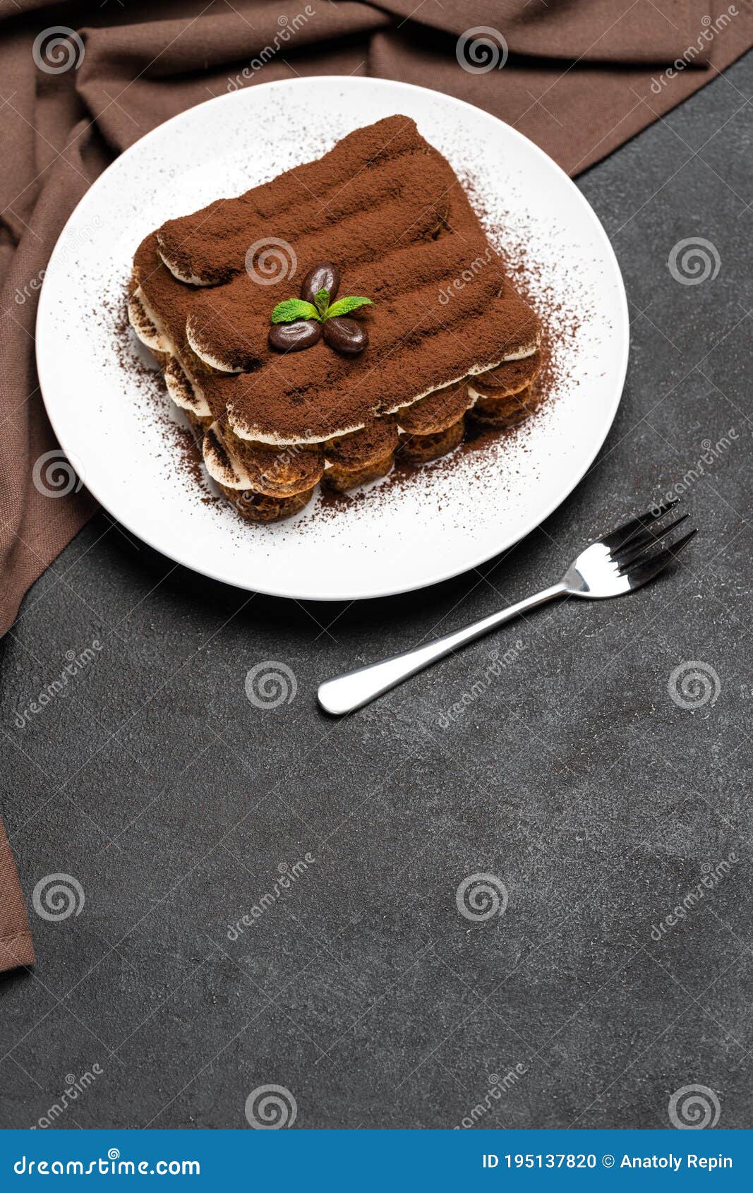 Classic Tiramisu Dessert on Ceramic Plate on Concrete Background Stock
