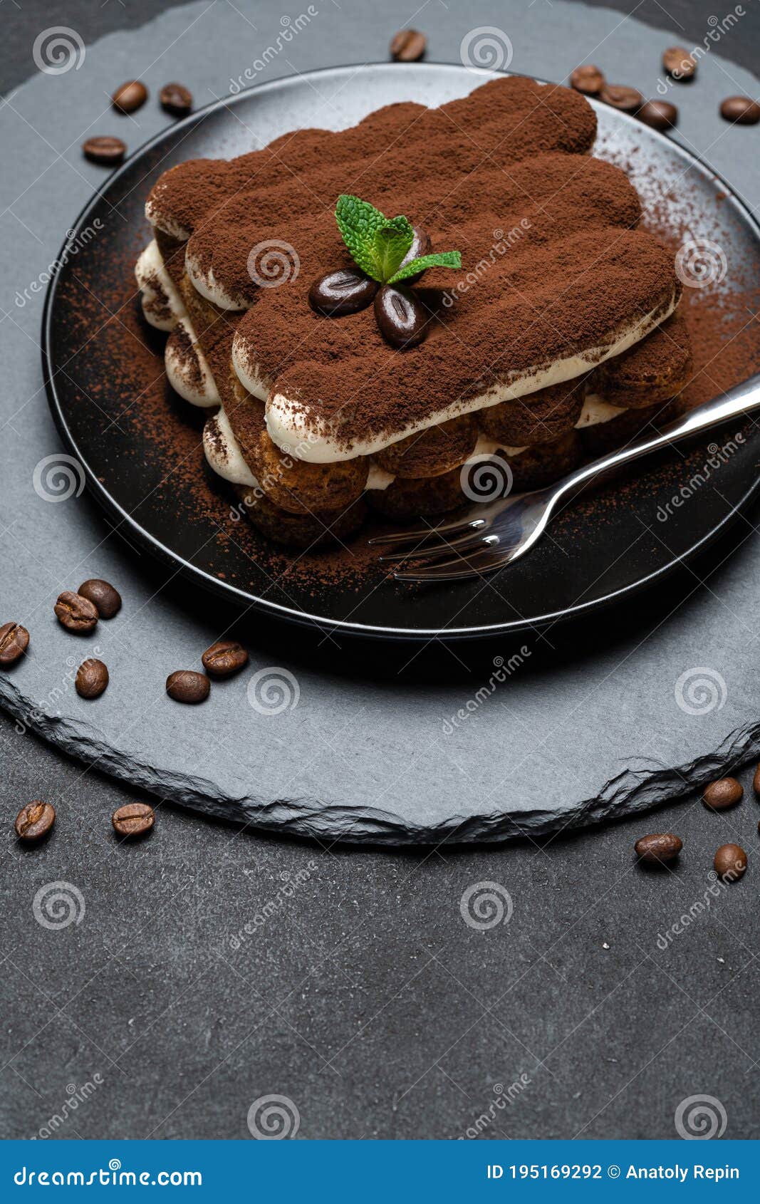 Classic Tiramisu Dessert on Ceramic Plate on Concrete Background Stock