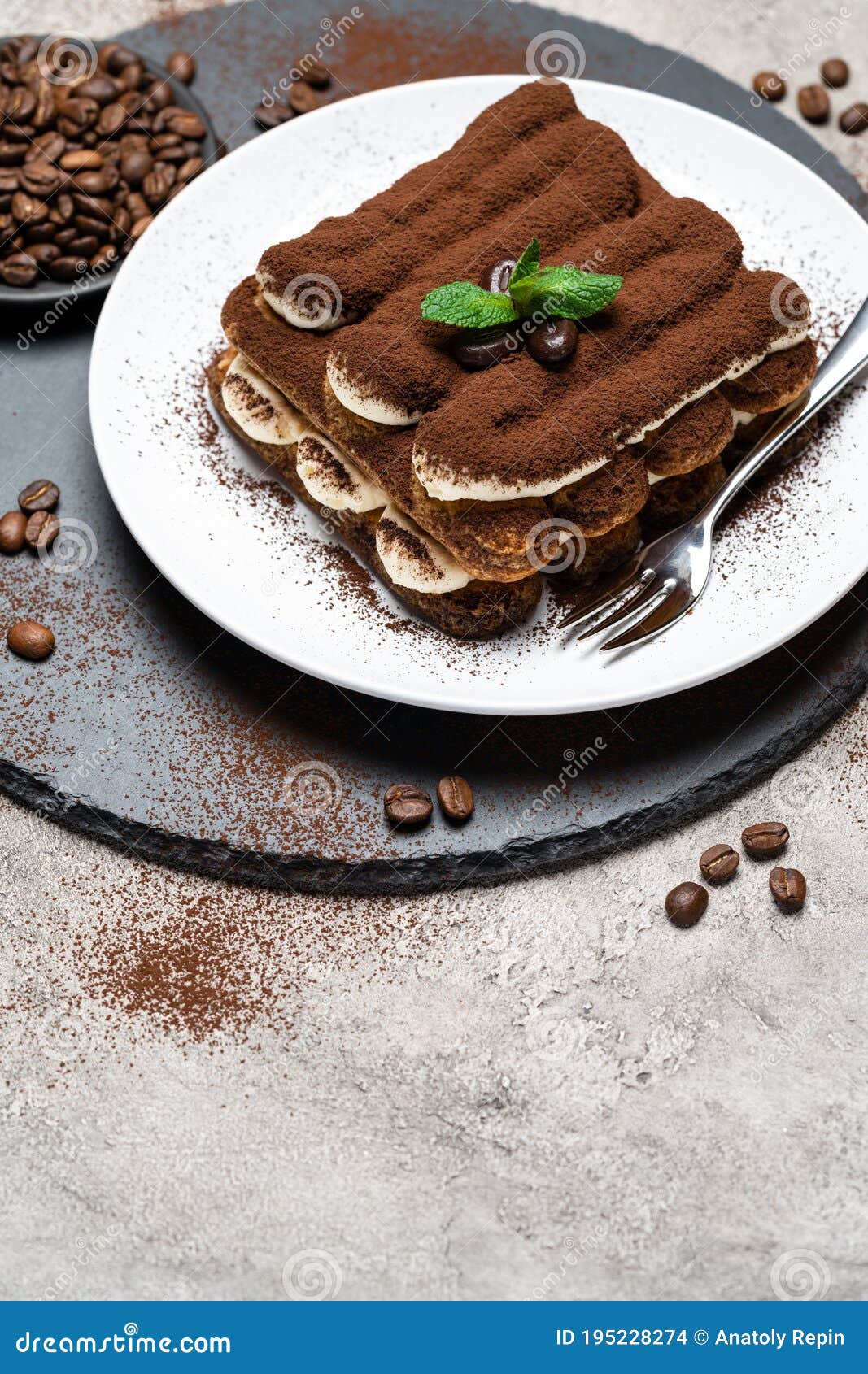 Classic Tiramisu Dessert on Ceramic Plate on Concrete Background Stock