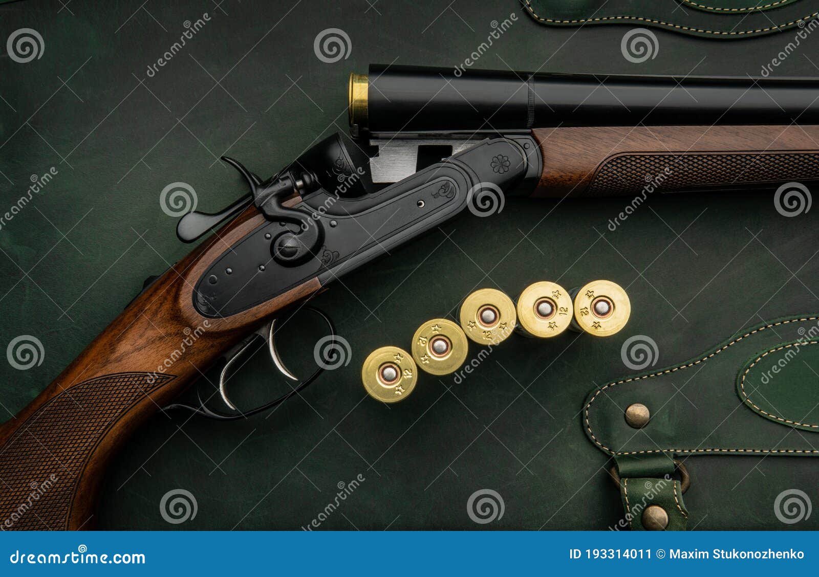 classic trigger double-barreled hunting rifle on a green background. smooth-bore hunting rifle open for reloading. concept