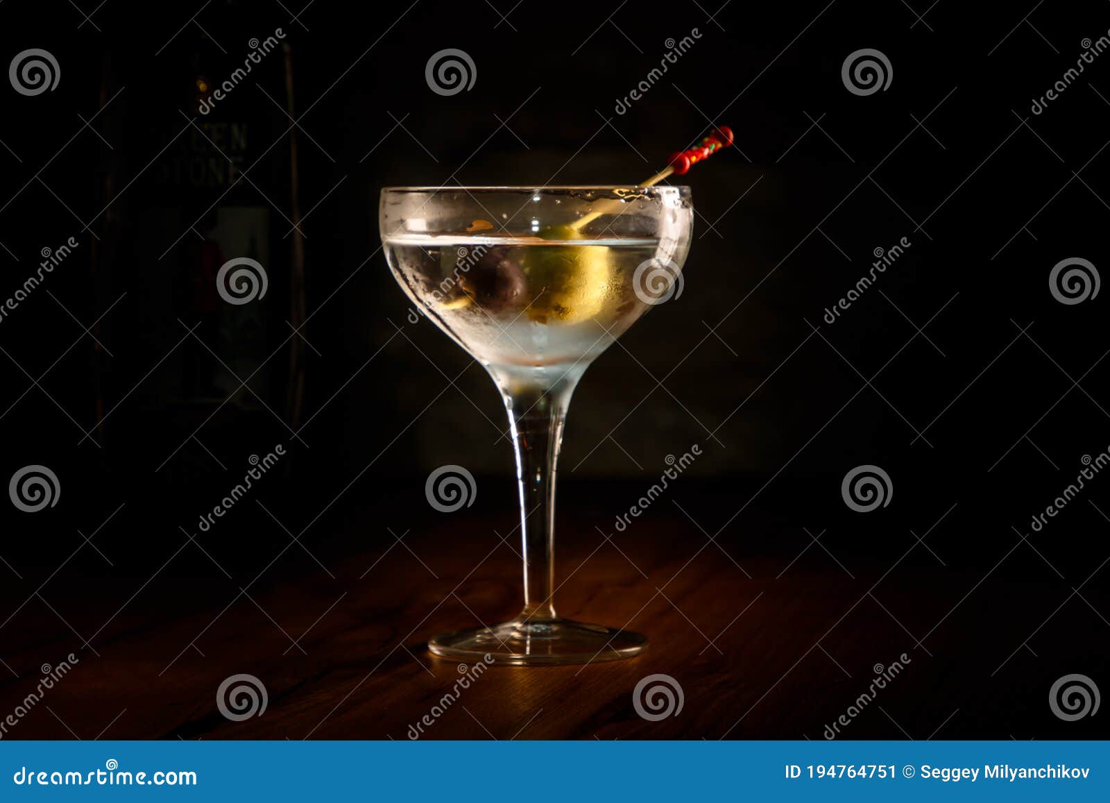 A Classic Vodka Cocktail with a Martini and Olives in a Glass is on the