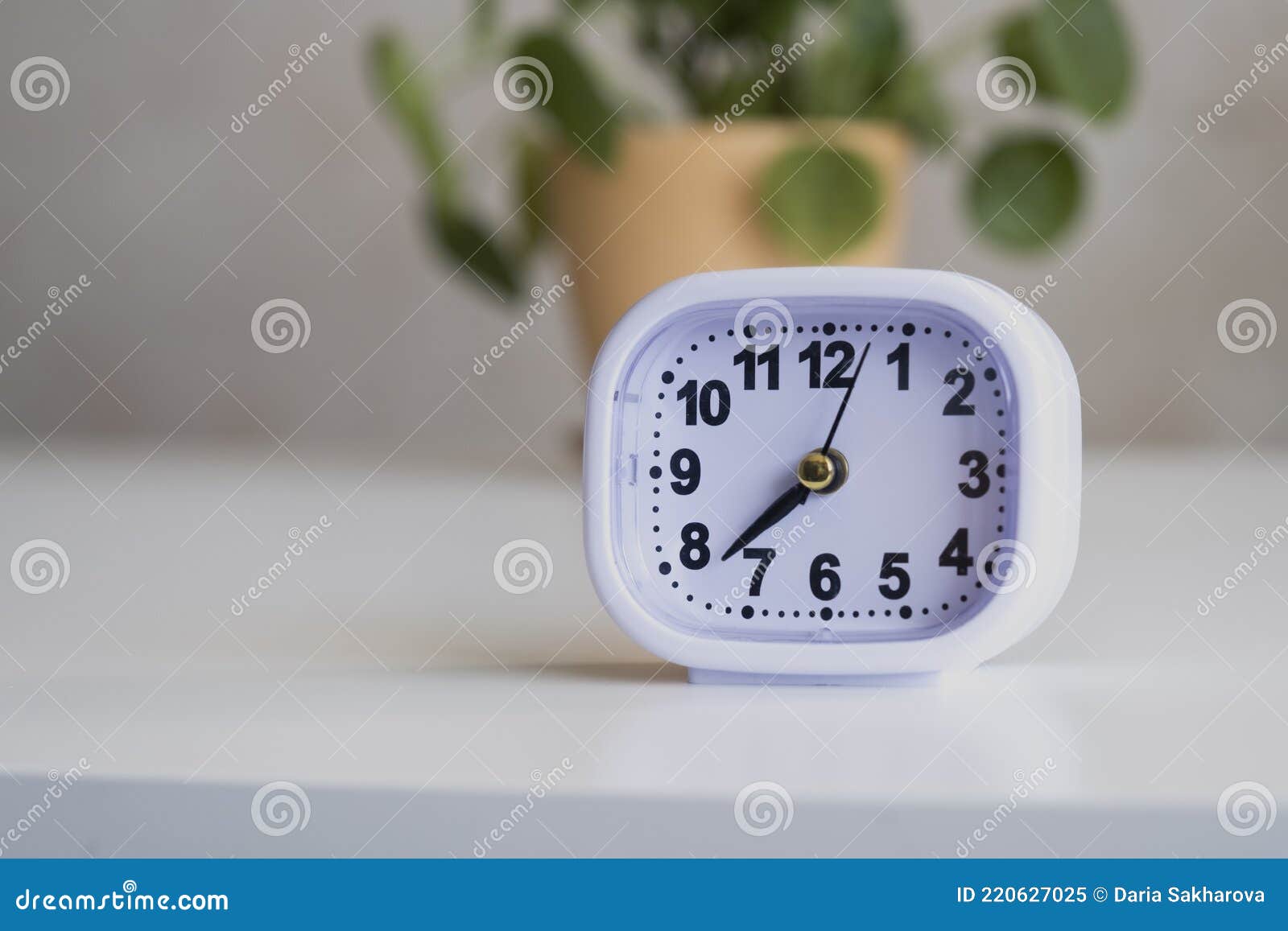 Classic White Alarm Clock. Clock on the Table in the Interior of the