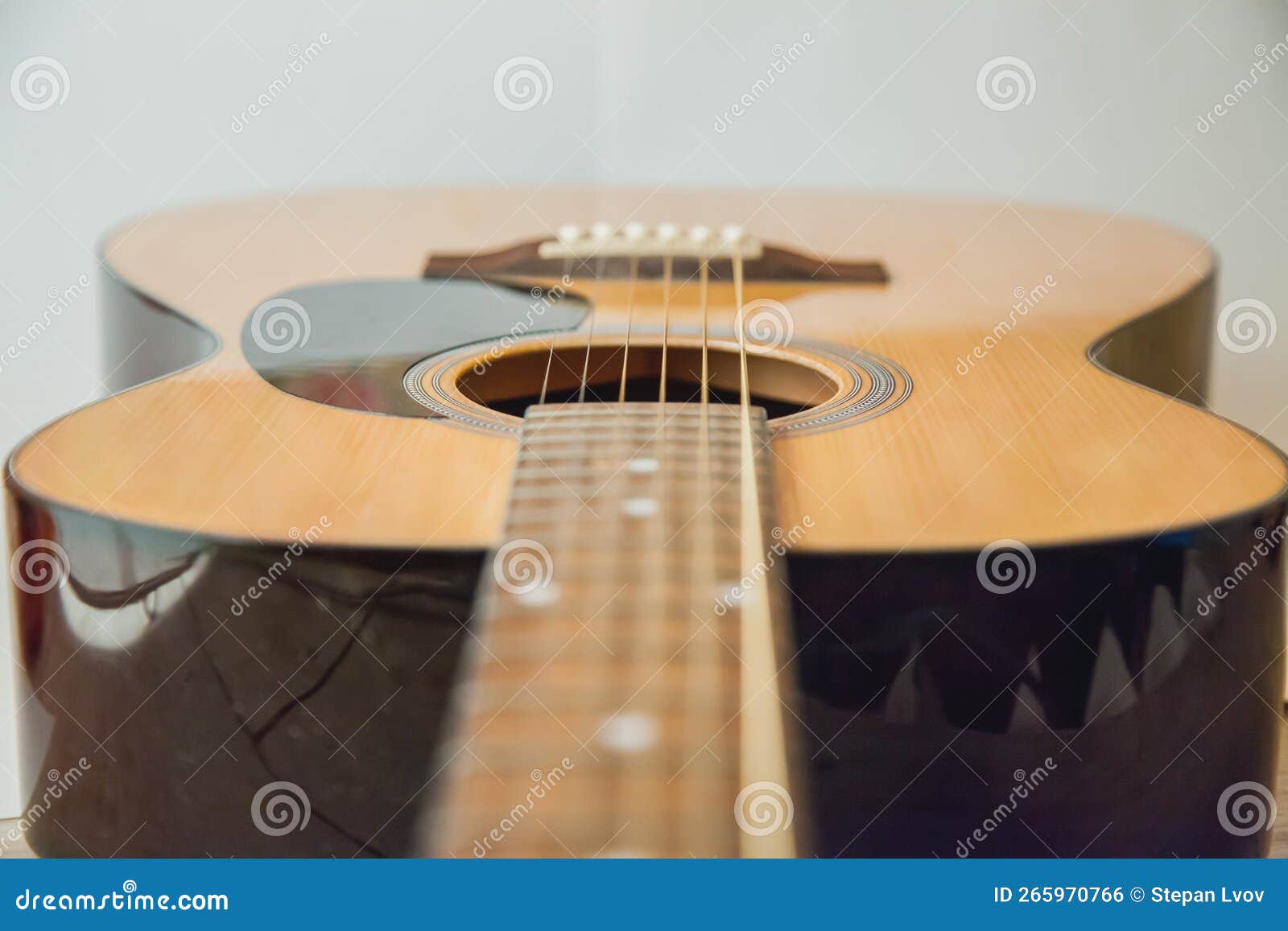 Classical Acoustic Guitar Detail of an Acoustic Guitar Behind a White