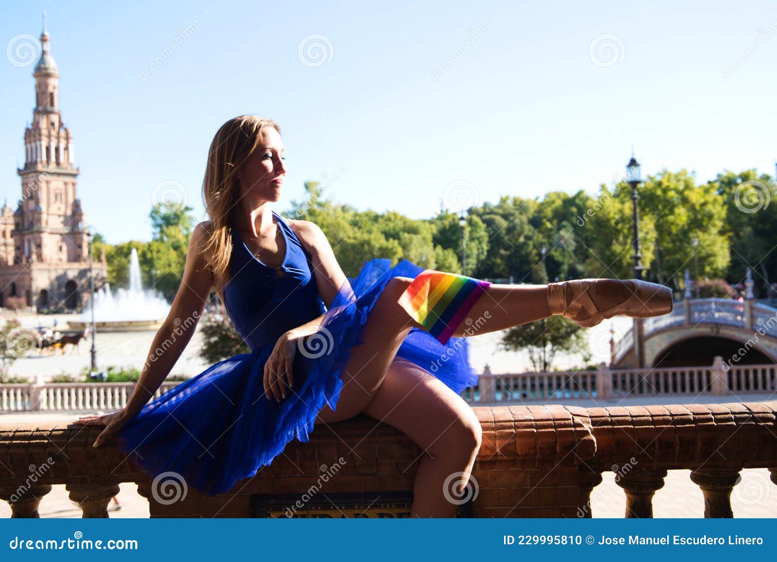 Classical Ballet Dancer And Lesbian Leaning On A Railing In A Park She Is Wearing The Gay Pride