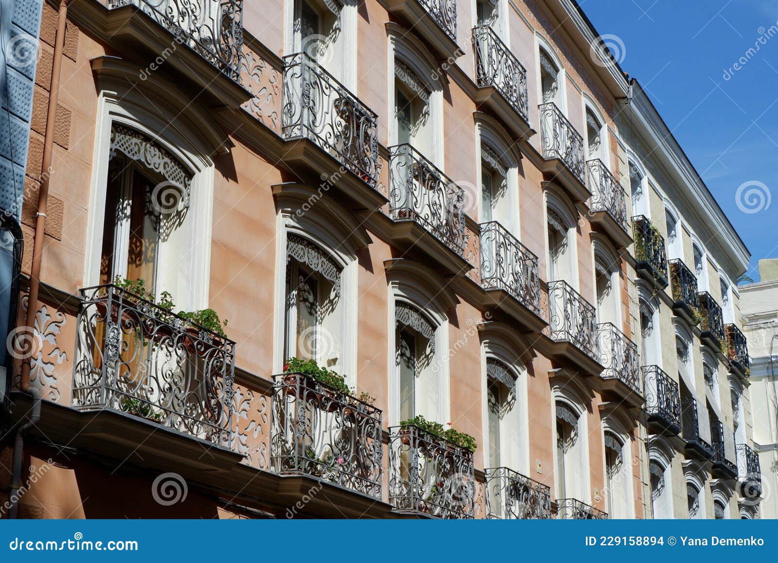classical vintage building facade with small elegant balconies in chueca district dowtown madrid