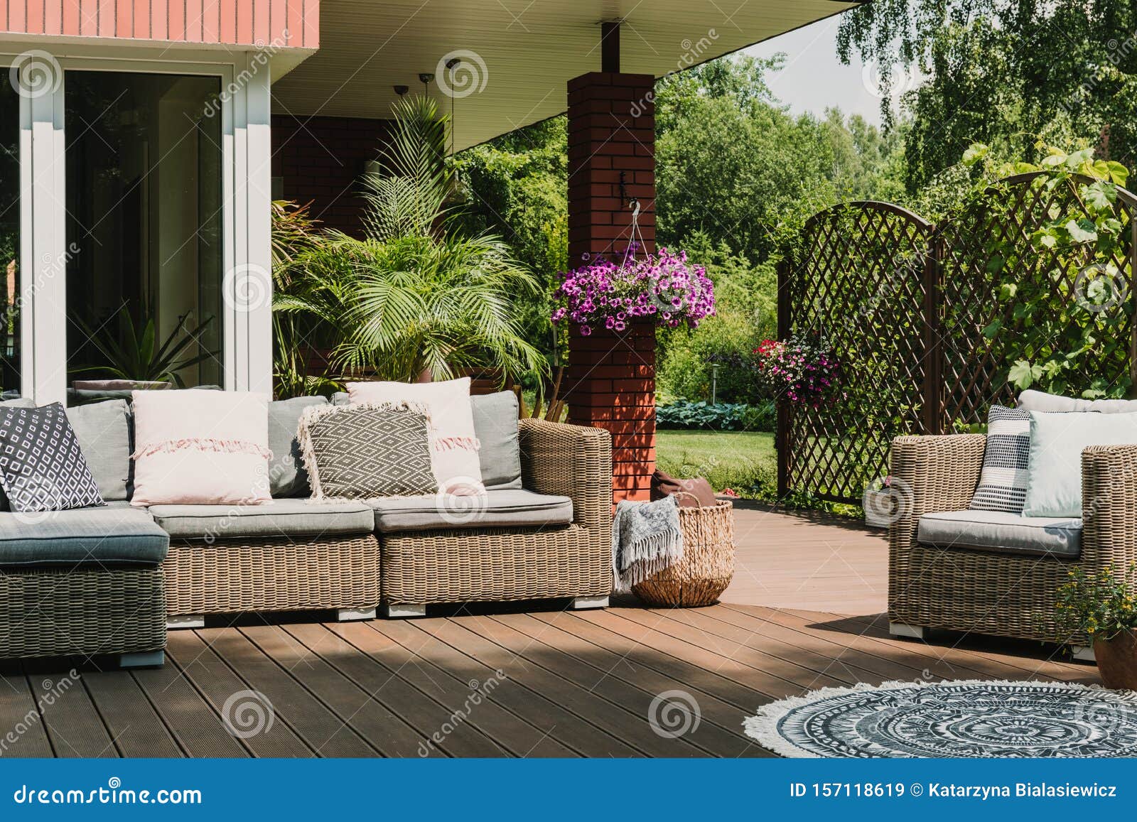 classy furniture on wooden terrace in green beautiful garden