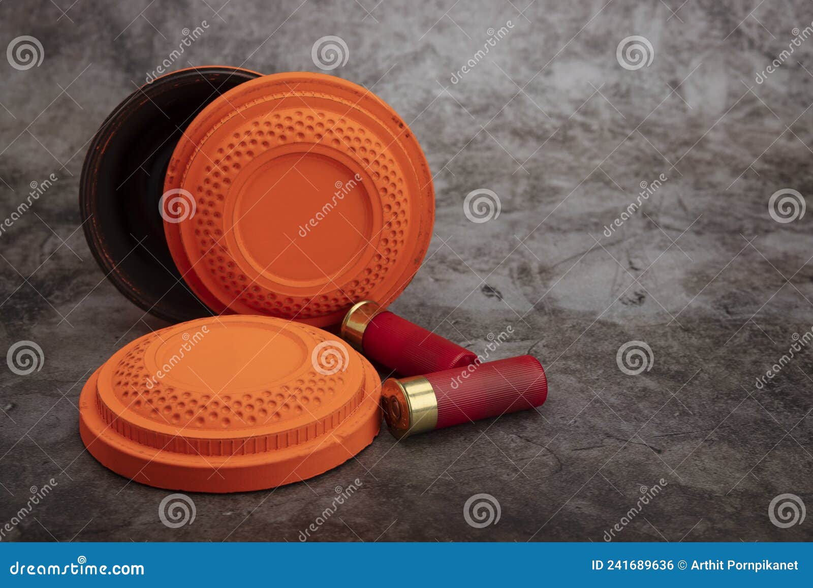 Clay Disc Flying Targets and Shotgun Bullets on Texture Background ,Clay Pigeon Target Game Stock Photo