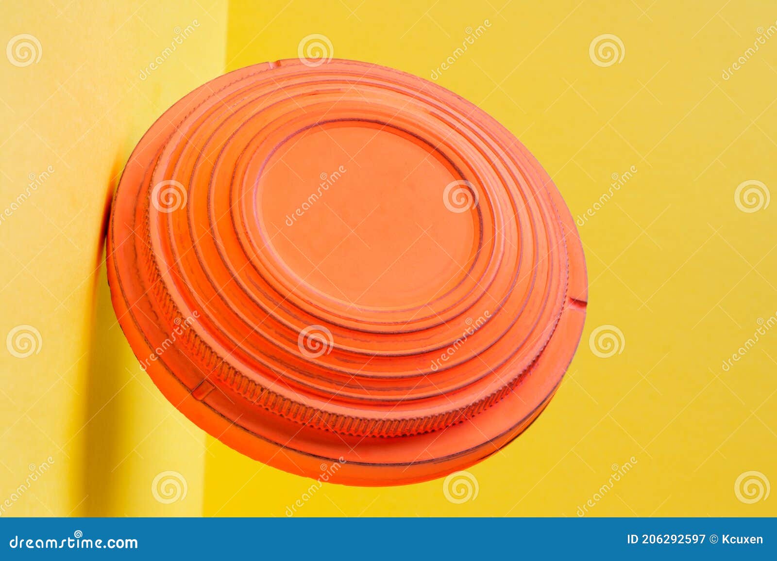 clay disc target for skeet shooting flying against the colorful yellow background