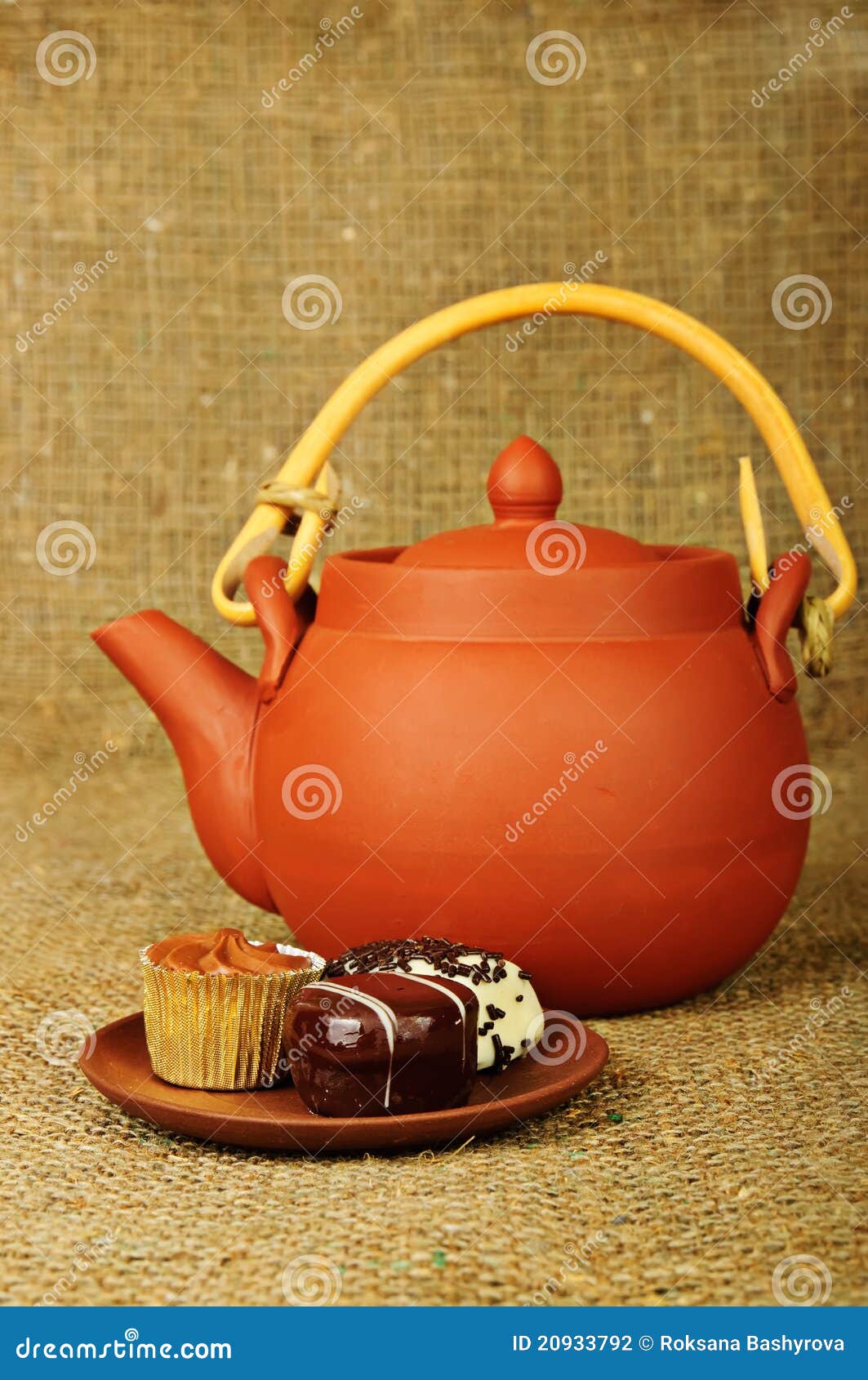 Clay teapot with sweets stock photo. Image of saucer 20933792