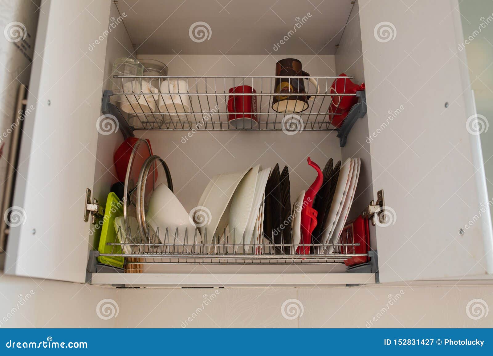 Clean Dishes In The Drying Cupboard Open Kitchen Cabinet Door With