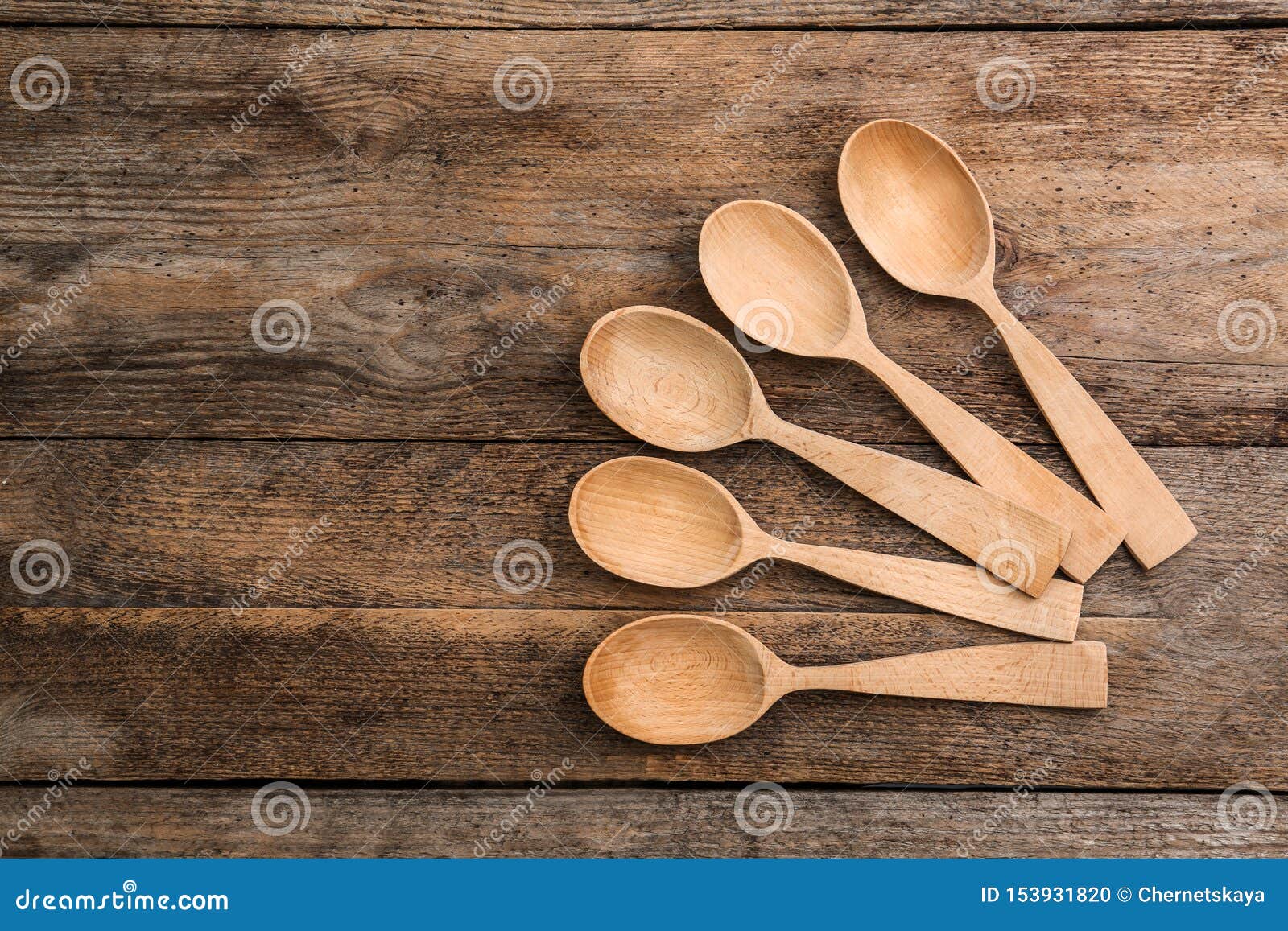 Clean Empty Spoons on Wooden Background, Top View Stock Photo