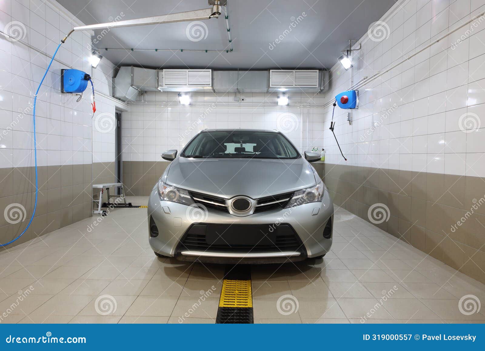 clean silver car is standing on the car wash,