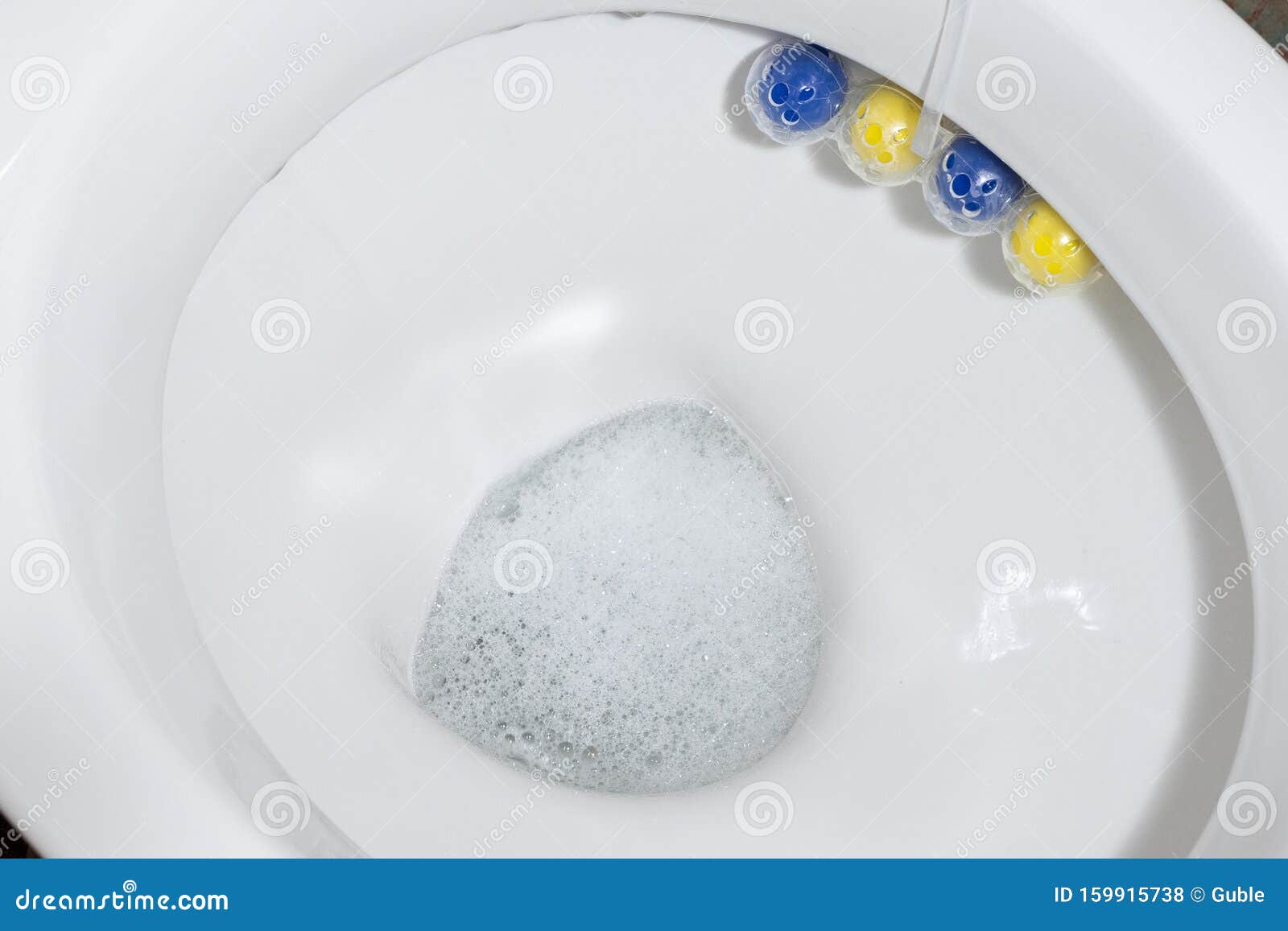 Clean Toilet Bowl with a Cleaning and Refreshing Balls. Close Up