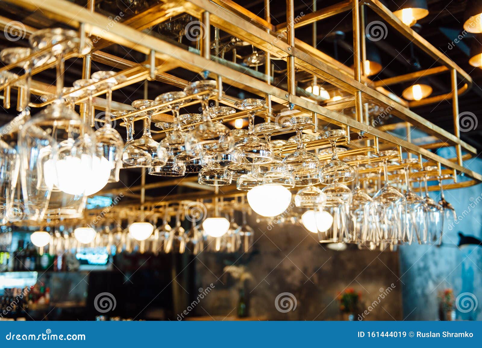 Clean Washed and Polished Glasses Hanging Over a Bar Rack Stock Image