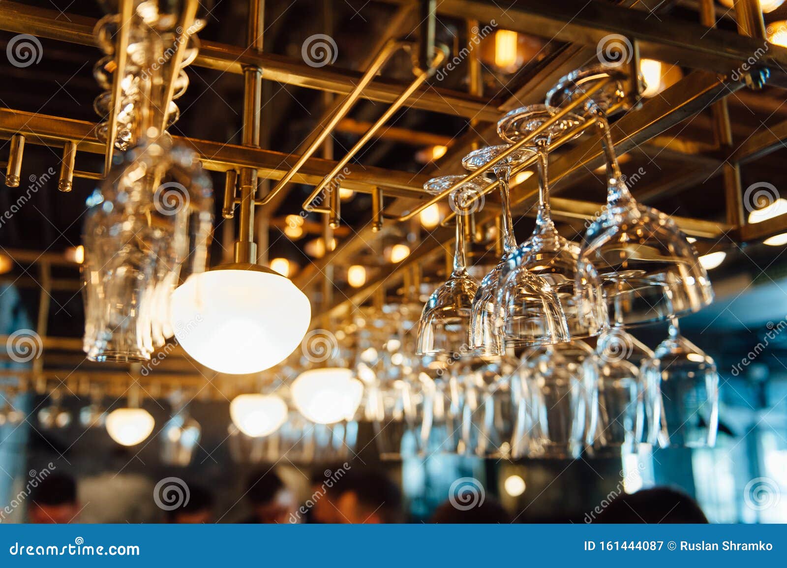 Clean Washed and Polished Glasses Hanging Over a Bar Rack Stock Image
