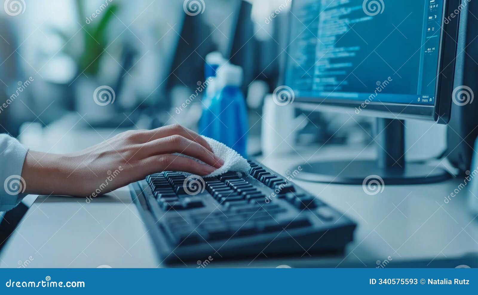 professional cleaner disinfects keyboard in a modern office environment during working hours, ensuring cleanliness