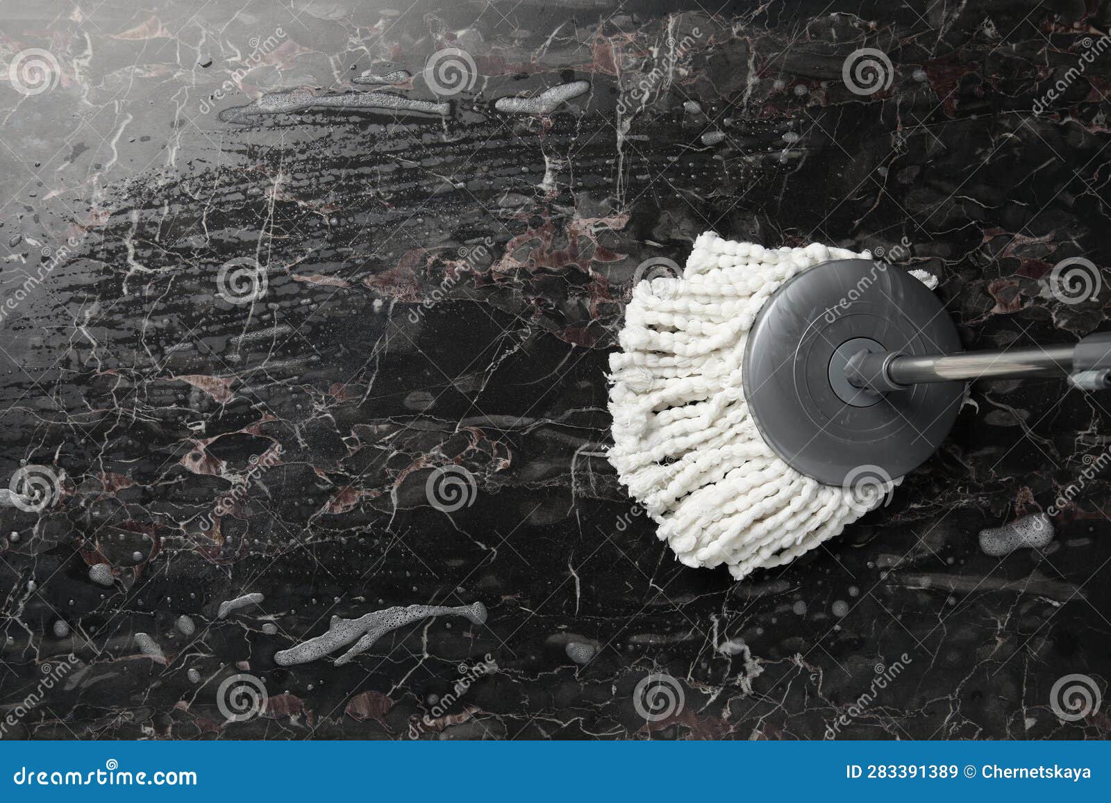 Cleaning Black Marble Floor with String Mop, Top View. Space for Text