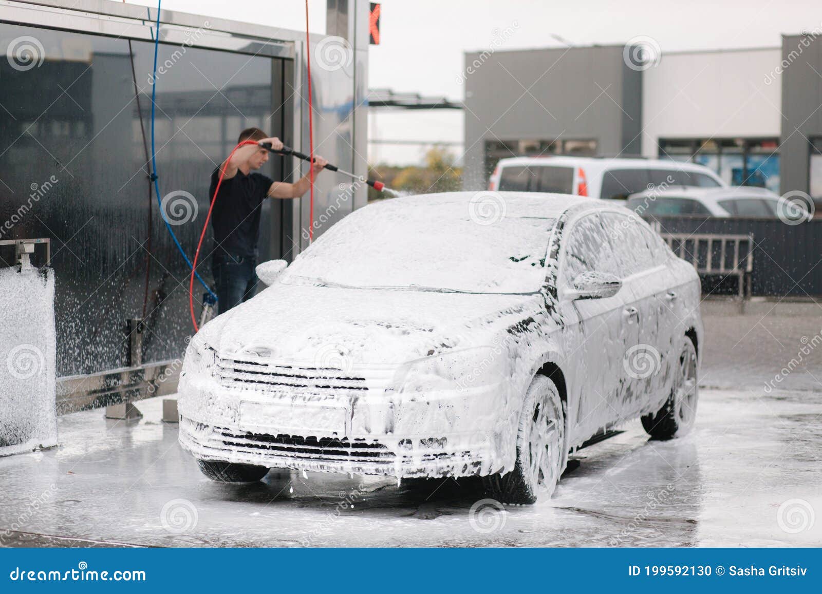 Cleaning Car Using Active Foam. Man Washing His Car on Self Carwashing