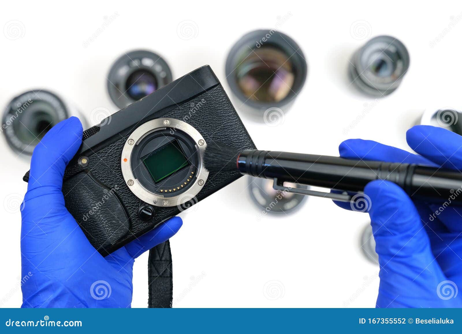 Cleaning Digital Camera, Hands Brushing Dust from Camera Mount Stock