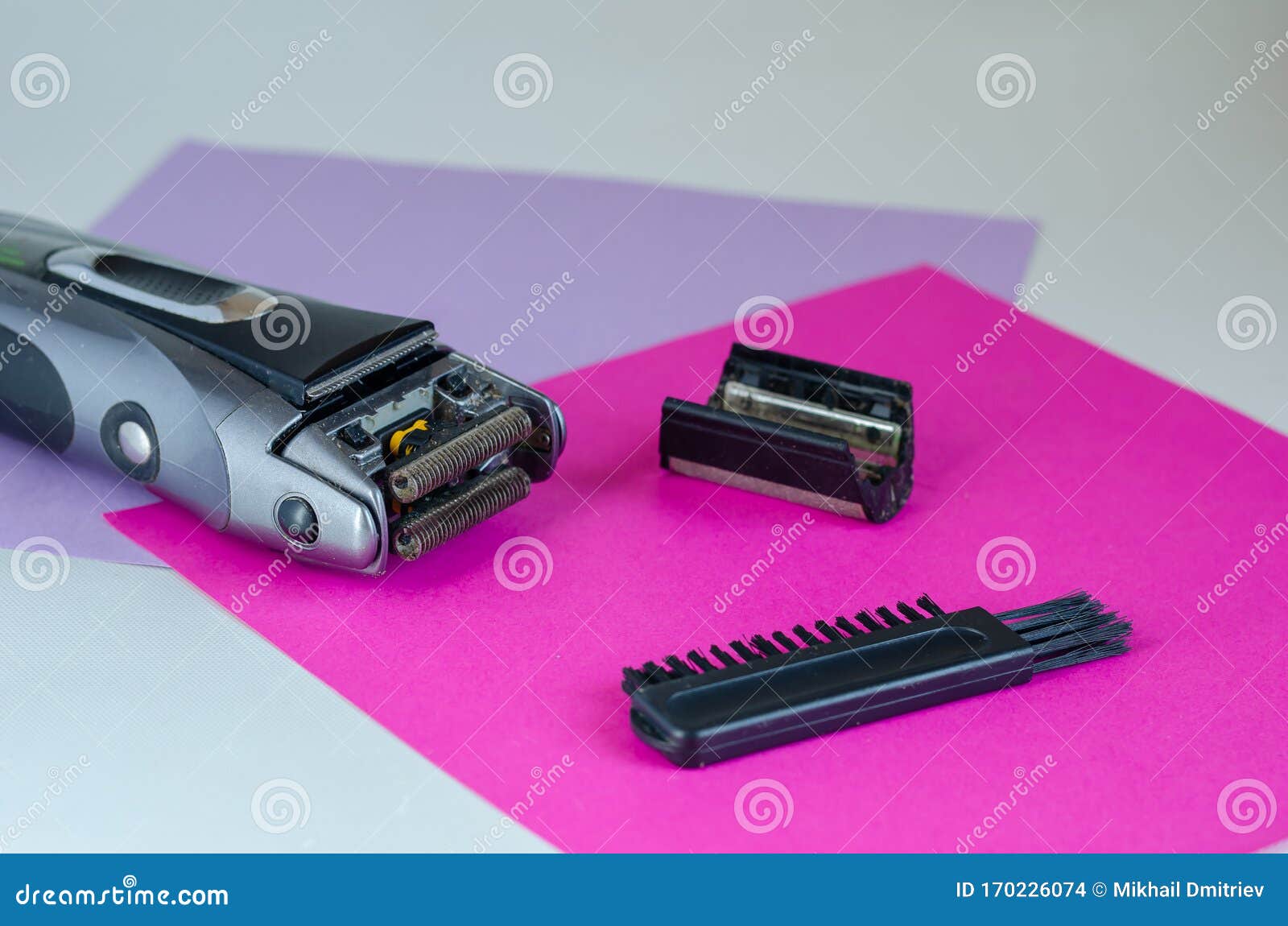Cleaning a Dirty Electric Shaver or Razor in the Bath Stock Photo