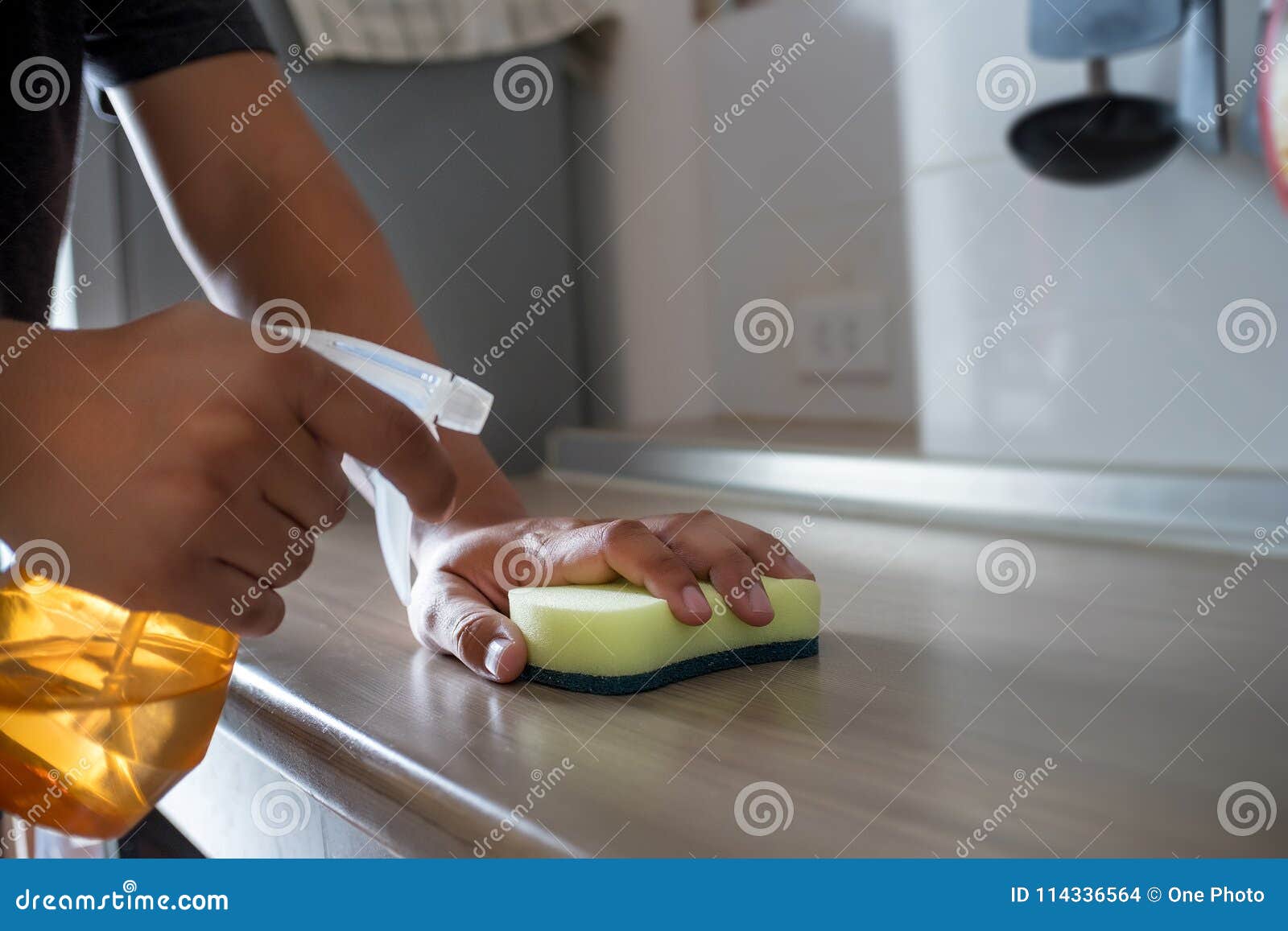 Cleaning Her House Using a Spray and a Duster Cleans Stock Photo