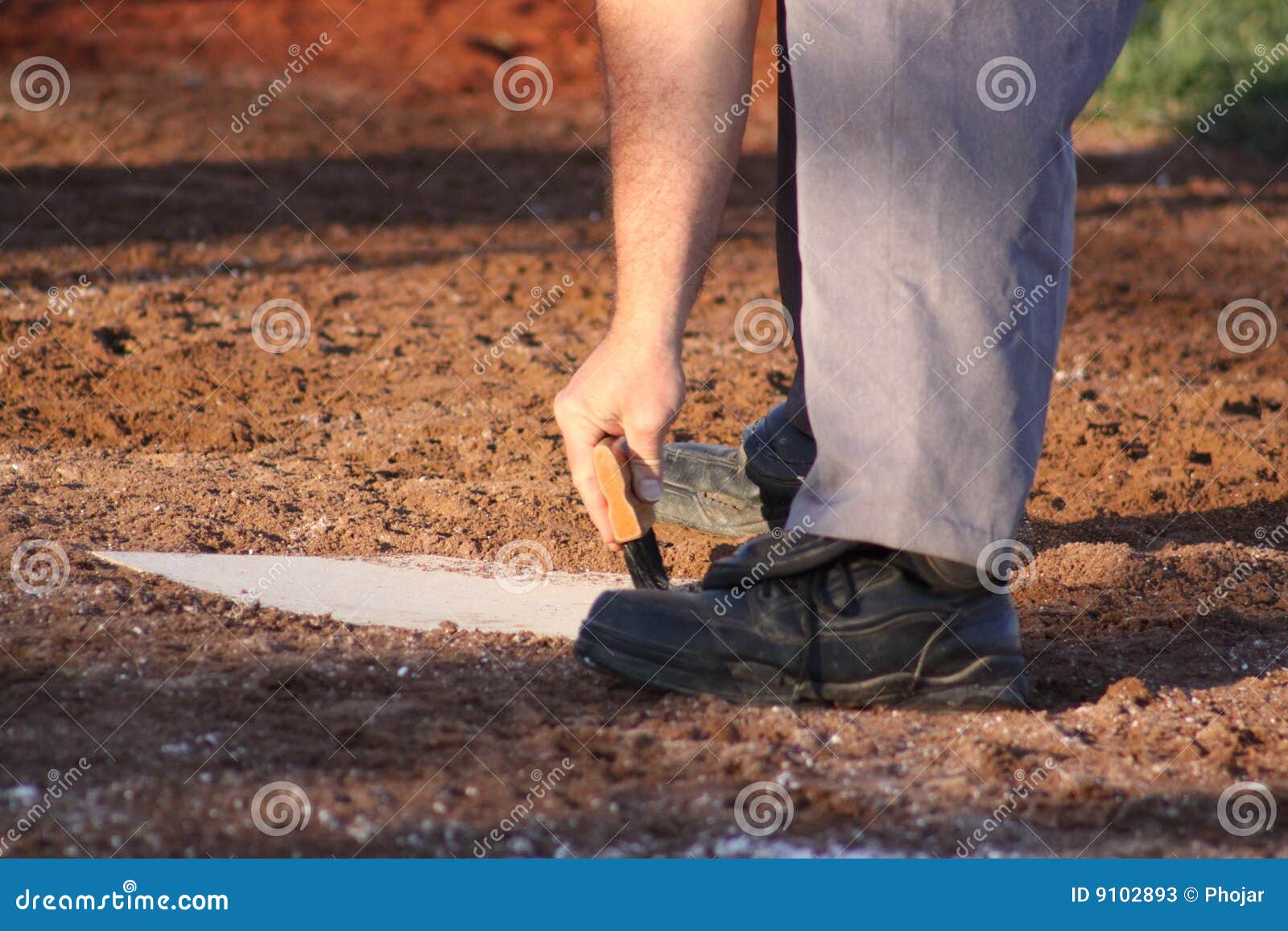 Cleaning home plate stock image. Image of sports, field 9102893