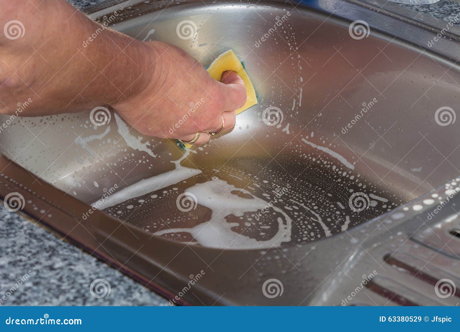 Cleaning a kitchen sink stock image. Image of backgrounds 63380529