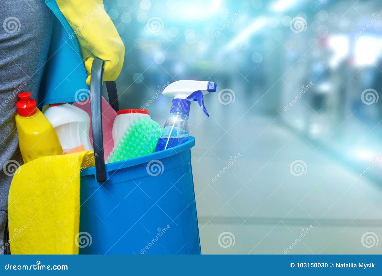 cleaning lady with a bucket and cleaning products .