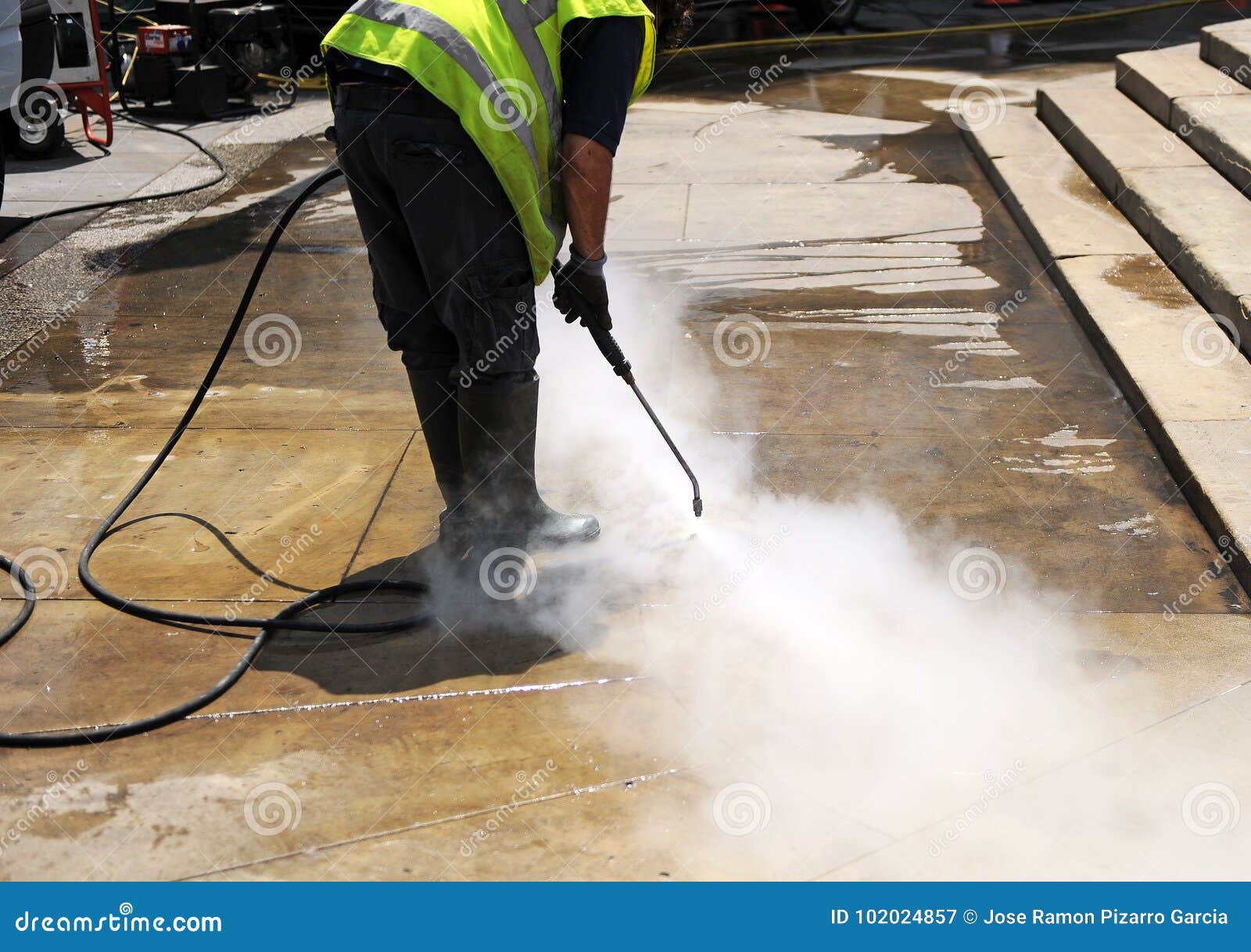 cleaning the pavement of the street with pressurized water