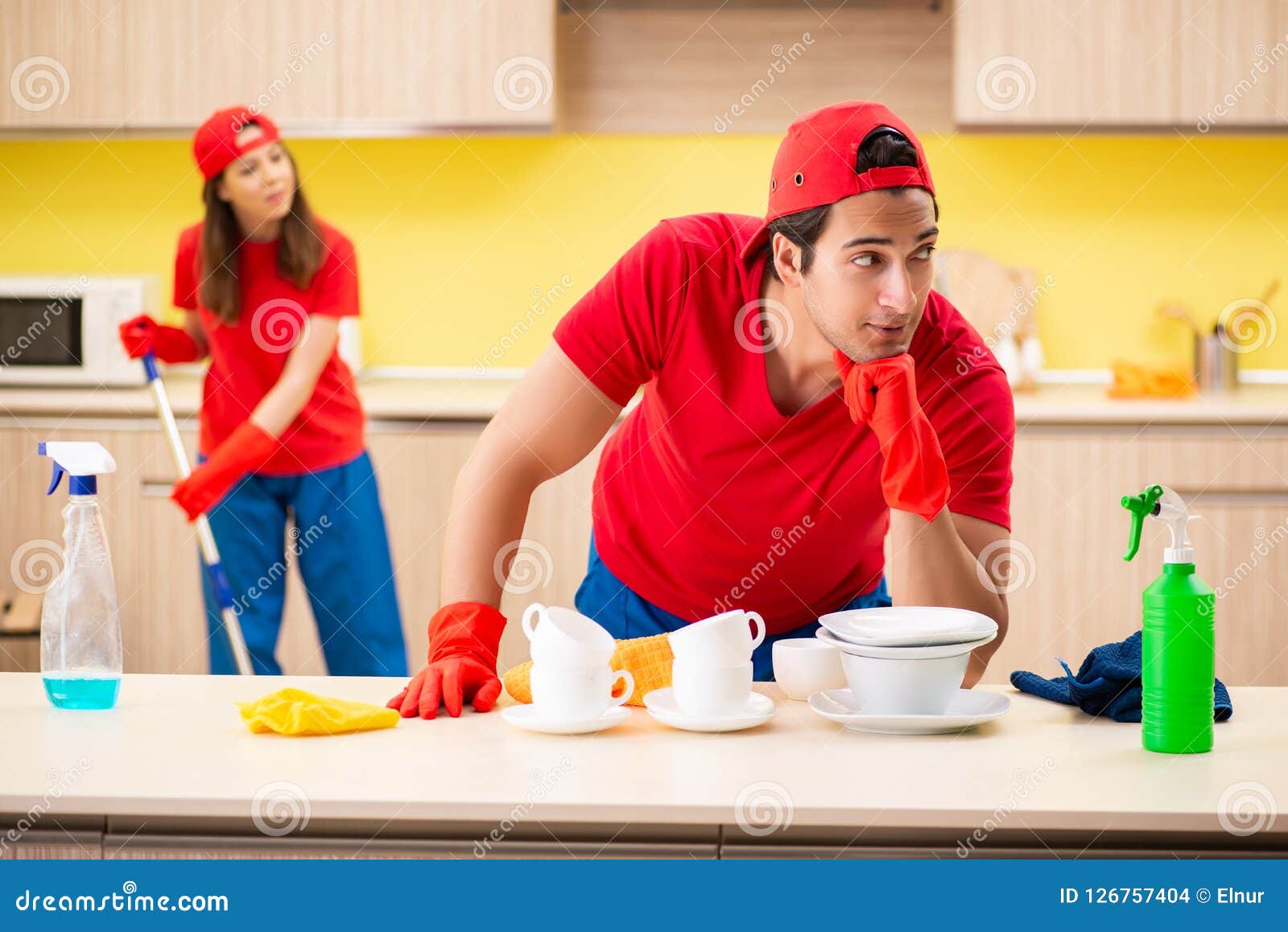 The Cleaning Professional Contractors Working at Kitchen Stock Photo