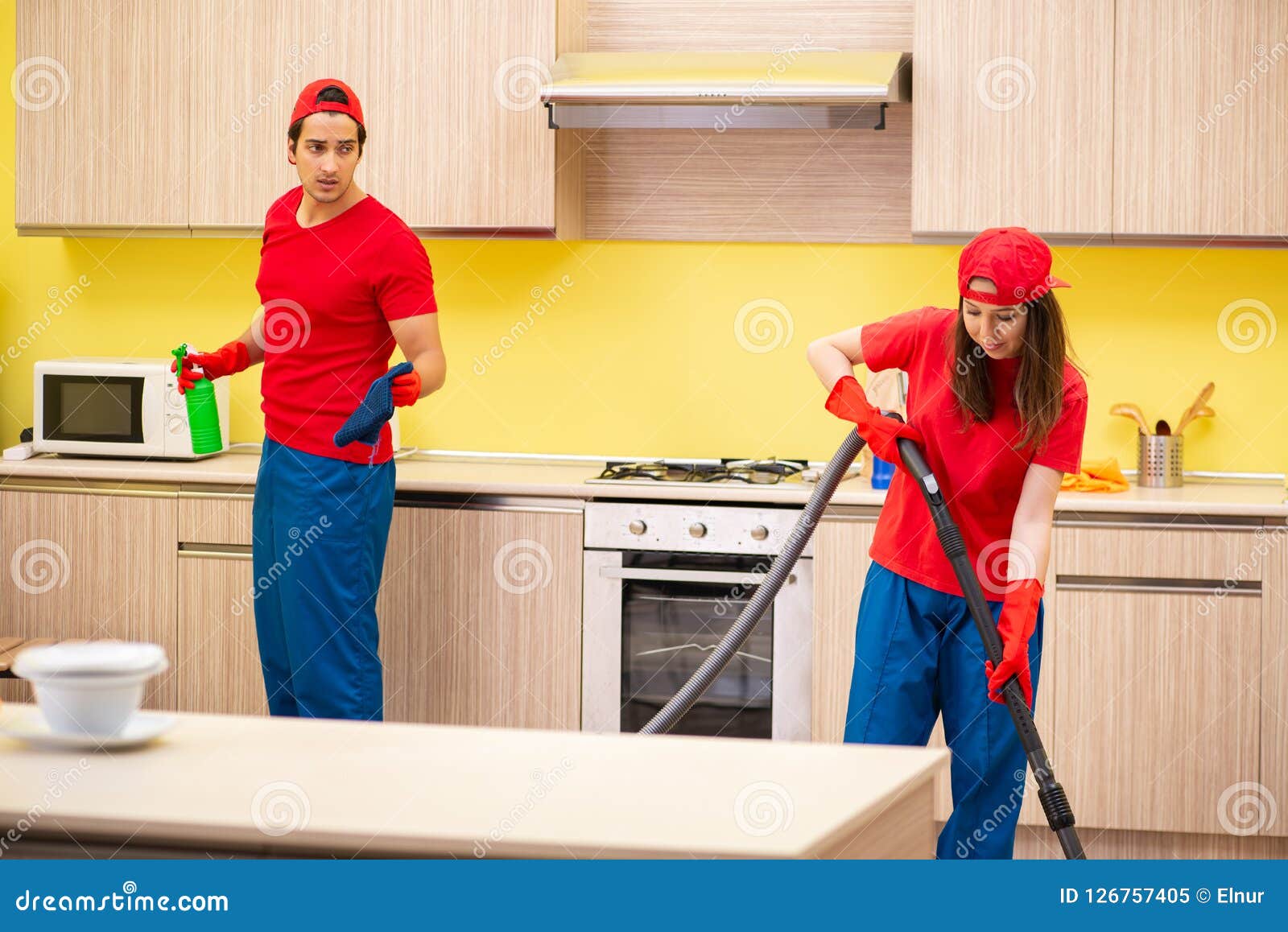 The Cleaning Professional Contractors Working at Kitchen Stock Image
