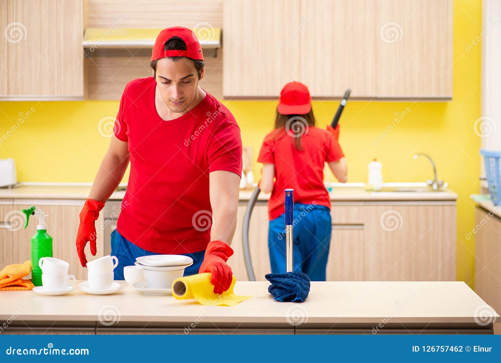 The Cleaning Professional Contractors Working at Kitchen Stock Photo