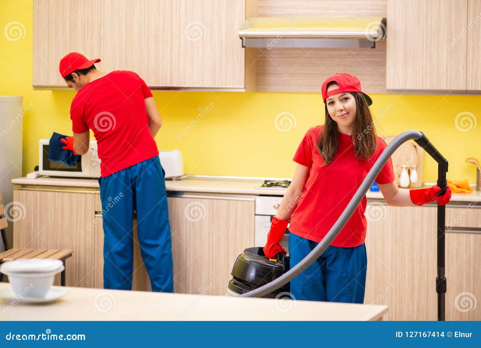 The Cleaning Professional Contractors Working at Kitchen Stock Photo