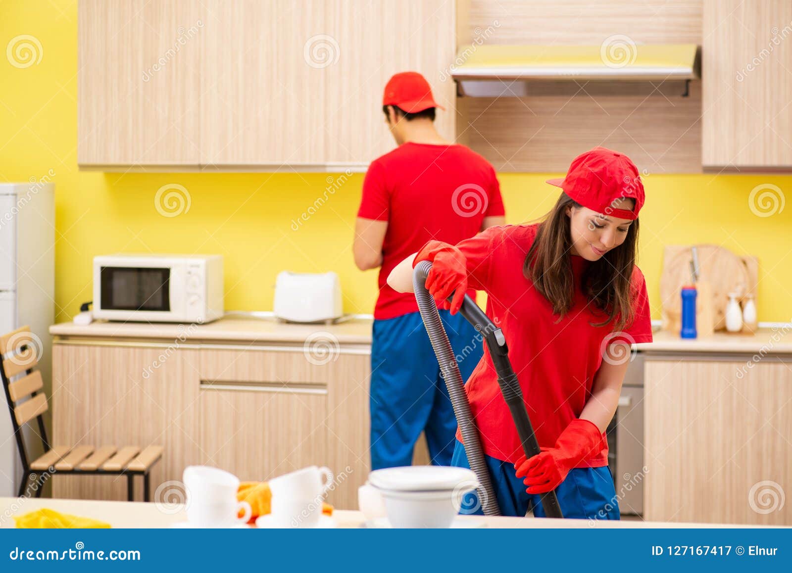 The Cleaning Professional Contractors Working at Kitchen Stock Image