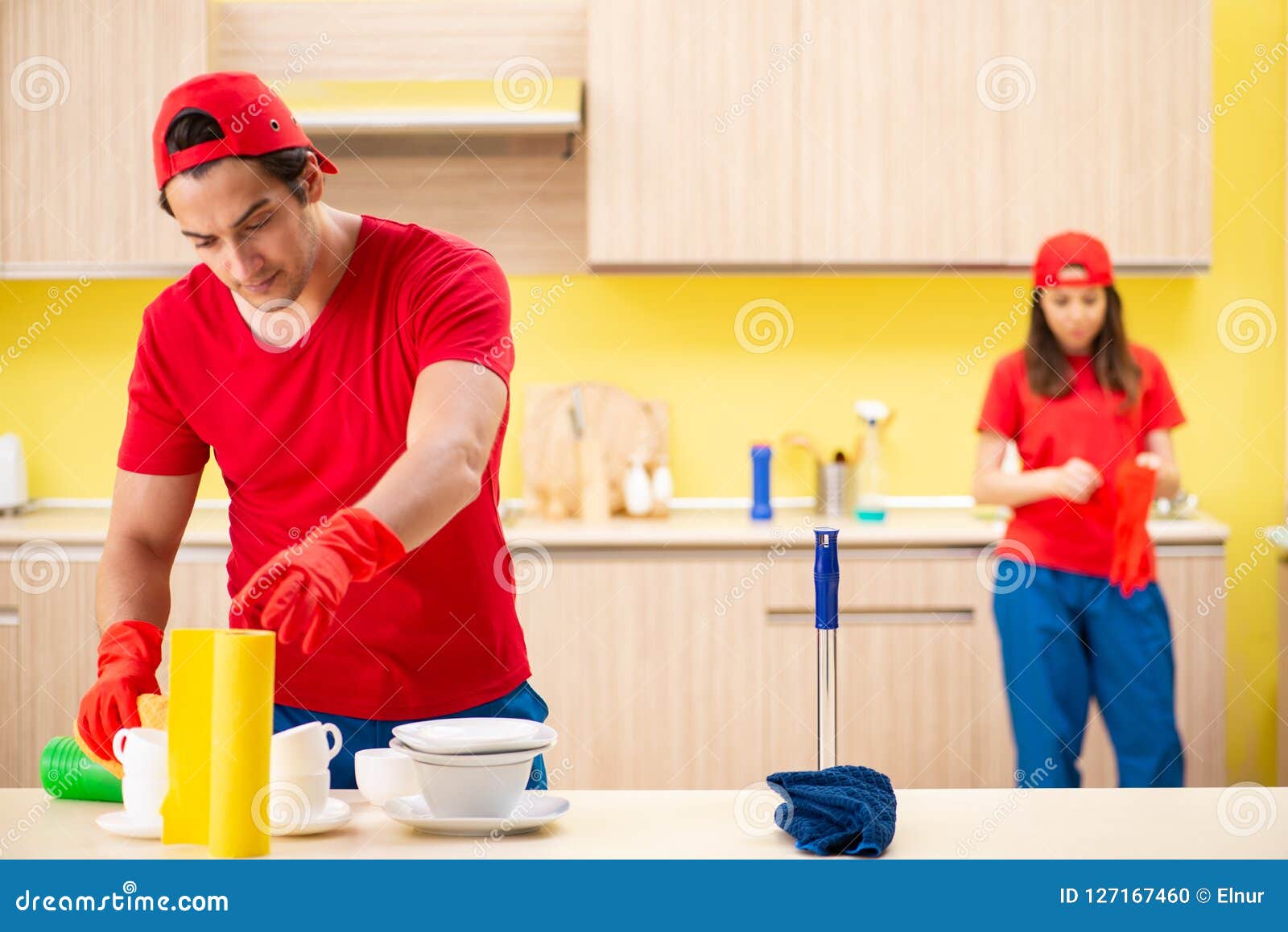 The Cleaning Professional Contractors Working at Kitchen Stock Photo