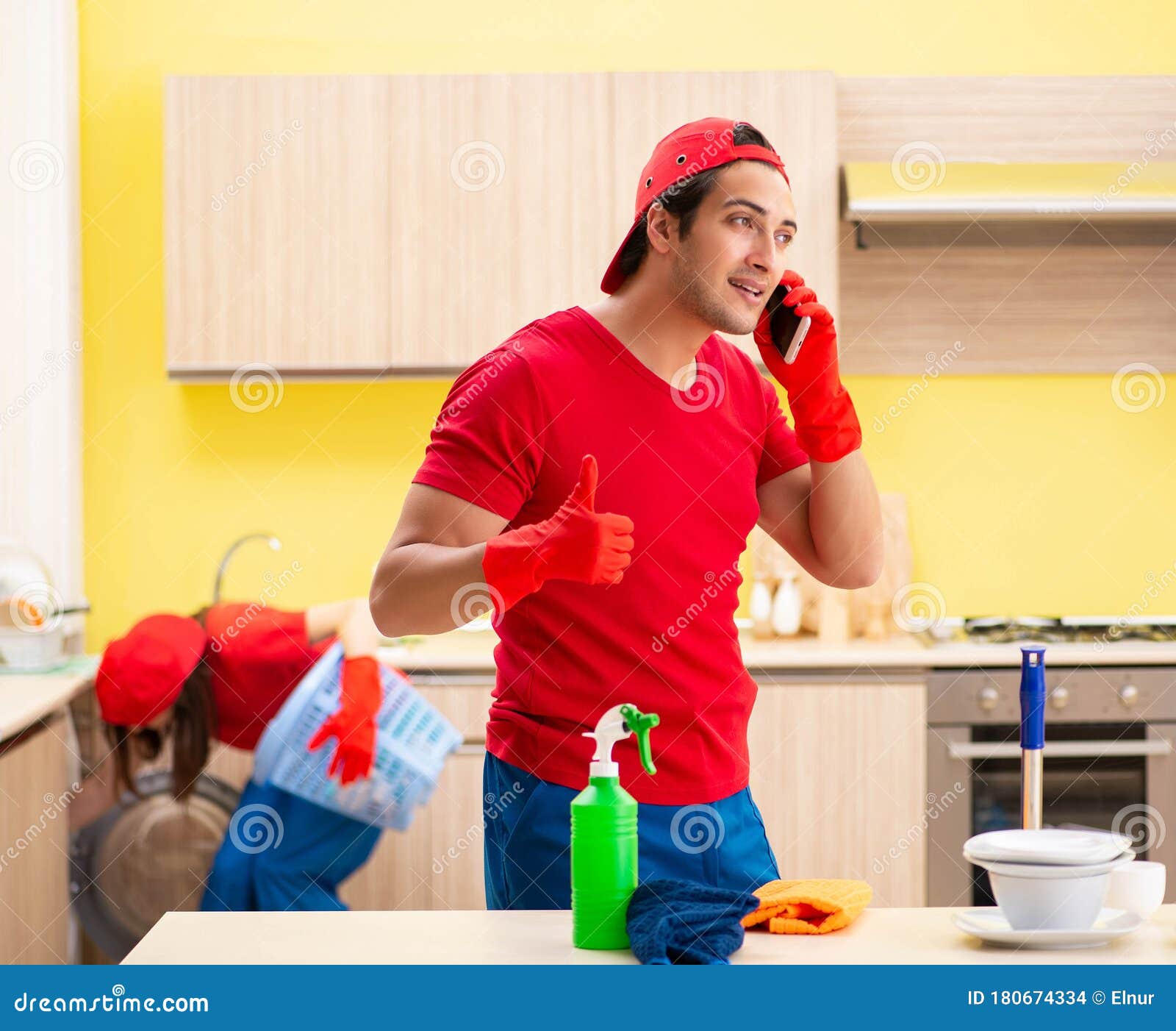 Cleaning Professional Contractors Working at Kitchen Stock Photo