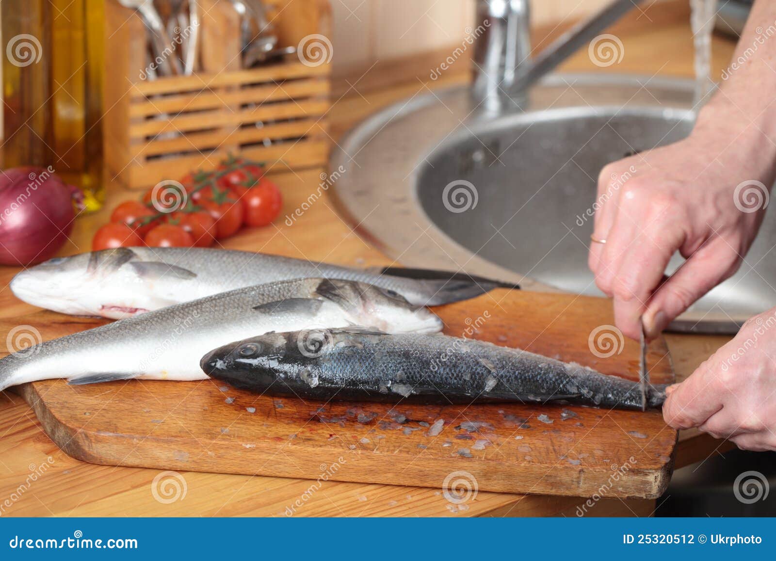 Cleaning a sea bass stock photo. Image of rustic, bass 25320512