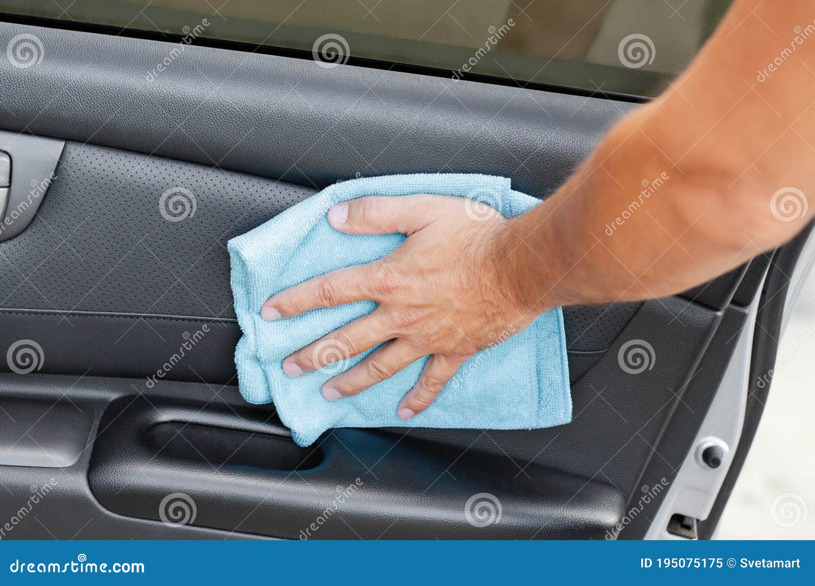 cleansing car interior and door. male hand  disinfecting vihicle