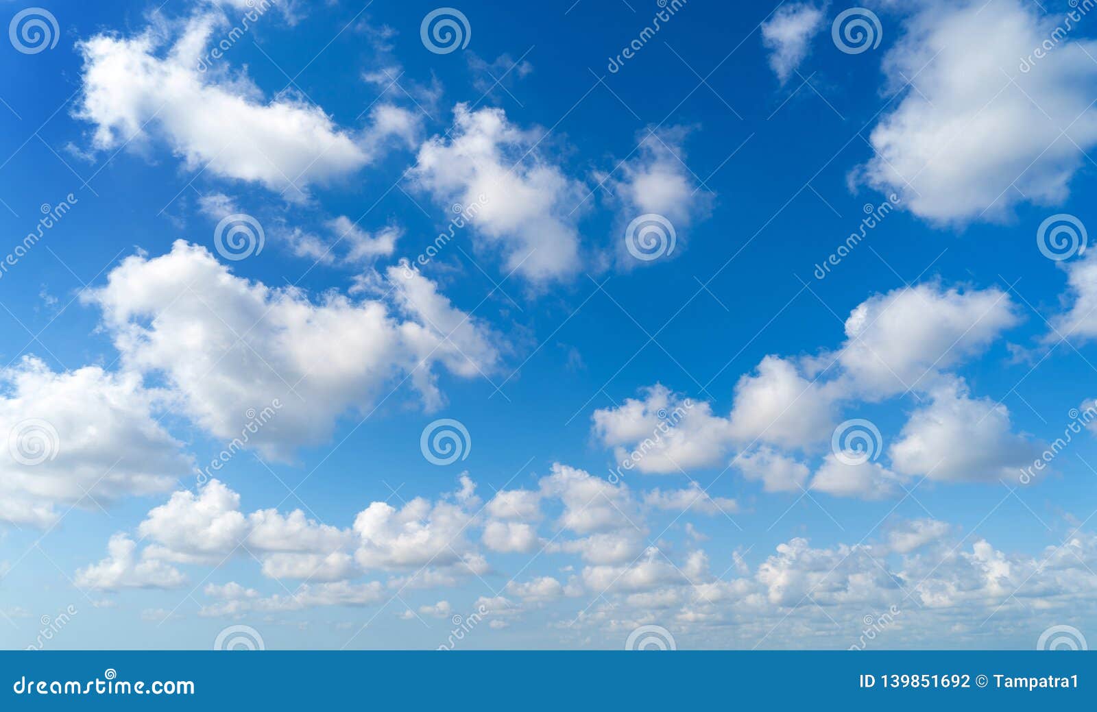 clear blue sky with white fluffy clouds. nature background