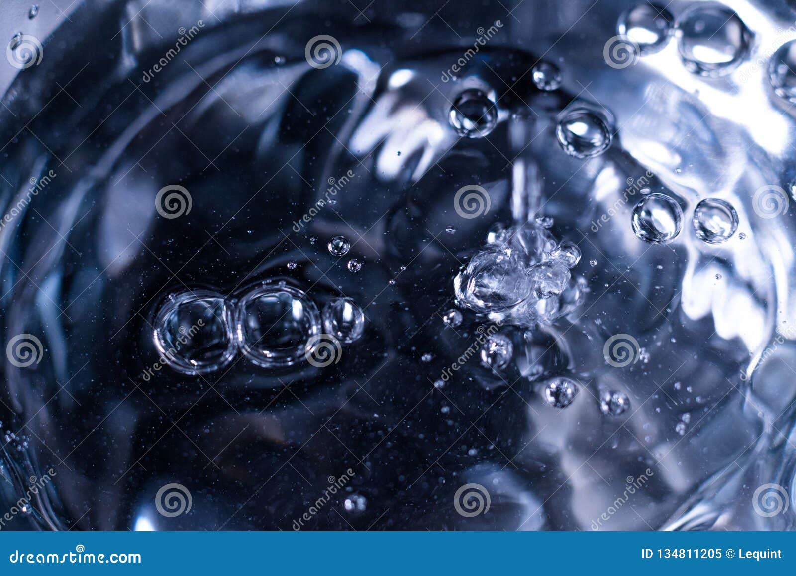 clear clean liquid water fluid poring into glass close up abstract