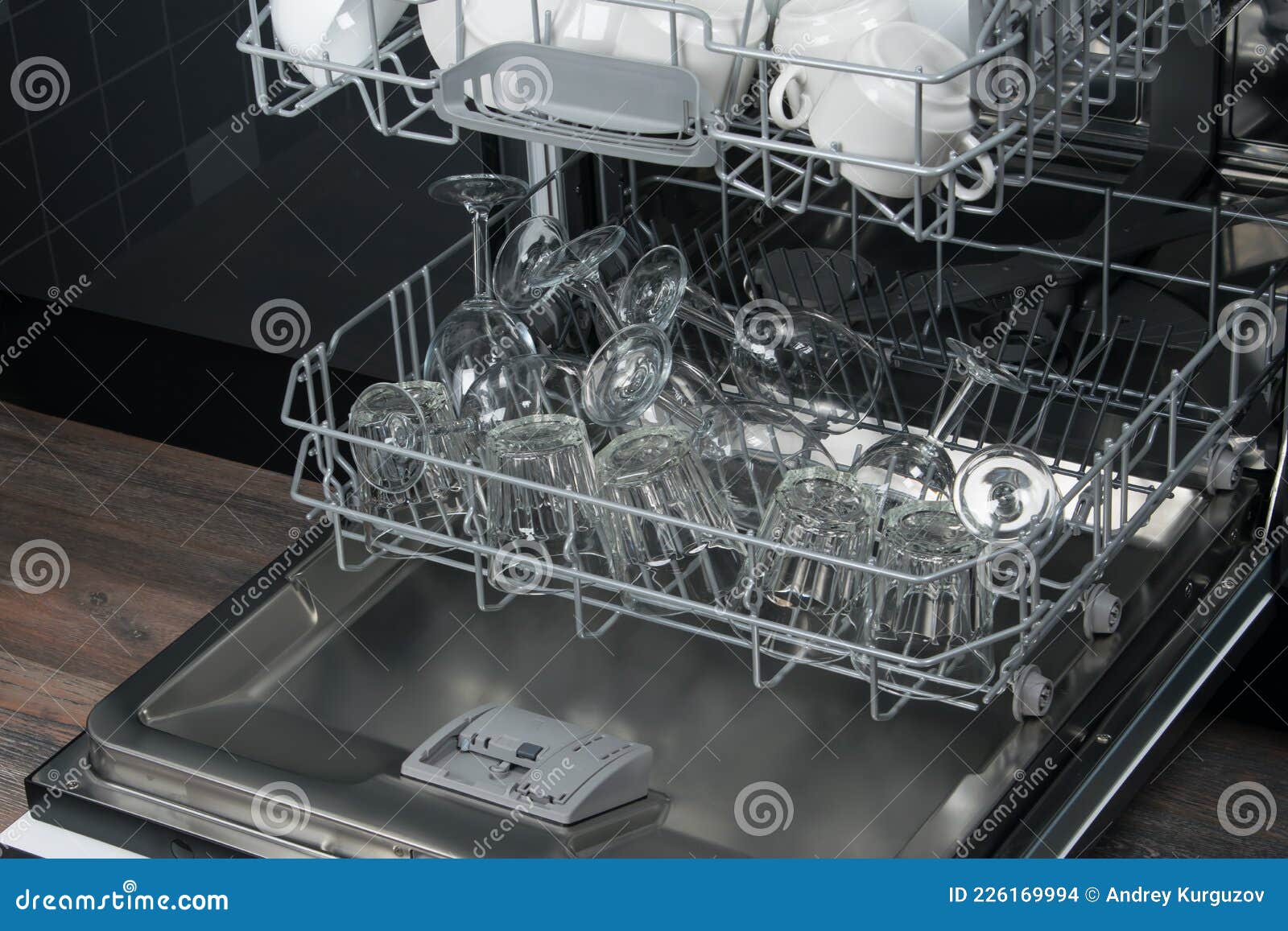 Clear Glasses in the Bottom Grid of the Dishwasher, after Drying Stock