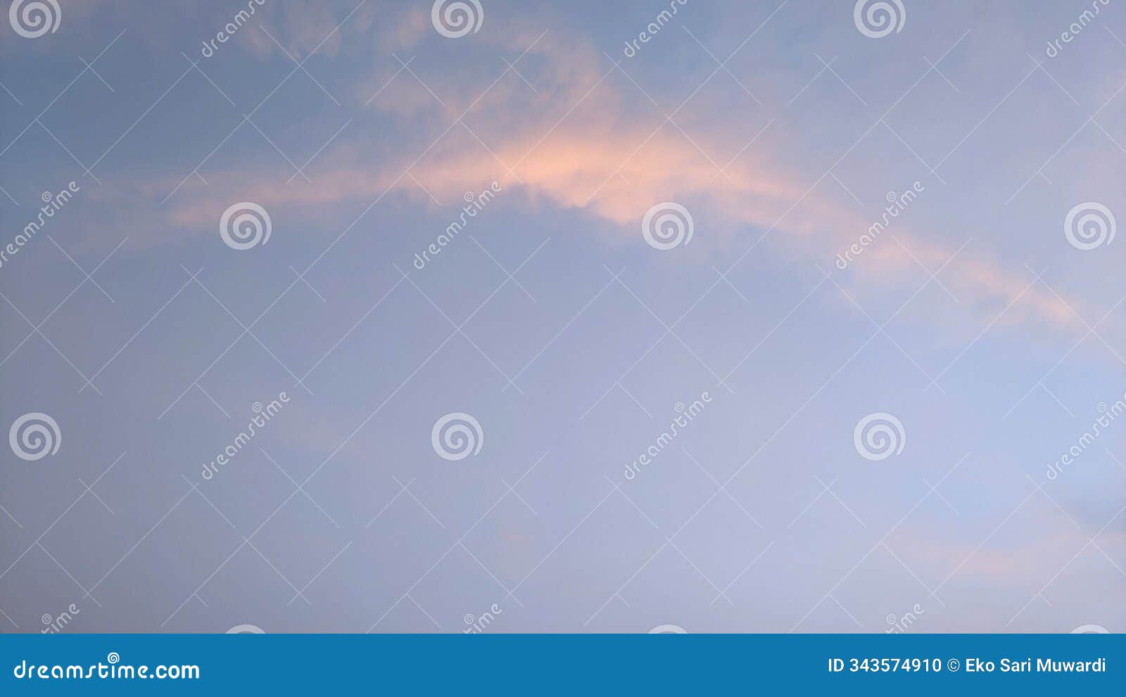 a clear, light blue sky with a single, wispy cloud tinged with pink. the cloud is positioned near the top of the image
