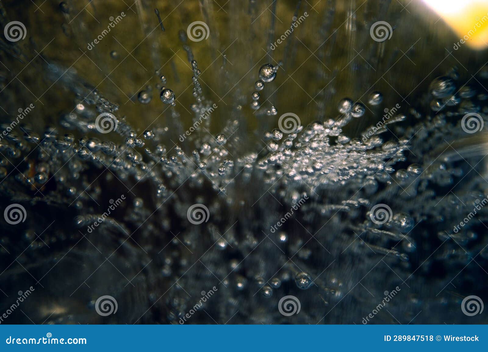 With Clear Liquid Pouring from a Spout into the Container Stock Photo