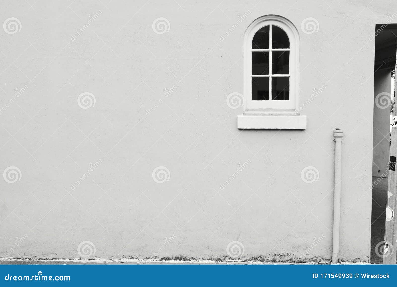 Clear White Wall with an Archshaped Window Perfect for Using As